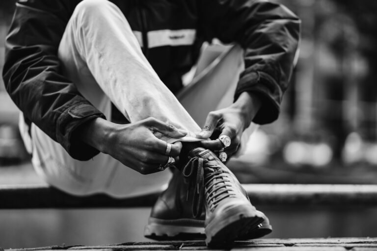 Person preparing to start a gym workout by tying their shoes, symbolizing motivation and the first step toward fitness consistency.”